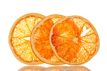 Three dry slices of grapefruit, macro, isolated on white background.