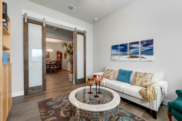 A home living room with a fireplace and large windows