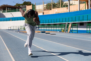 African runner starting a race on an athletics track