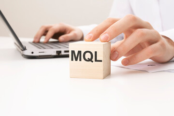 MQL text wooden block on white table background. marketing concept