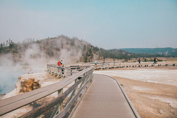 Wooden flooring for tourists in valley of geysers in Yellowstone National Park.