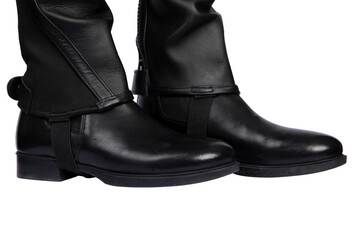 black boots and leather mini chap  for horseback riding, isolated on white. Closeup view