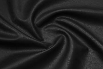 black artificial leather with waves and folds on PVC base