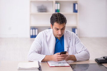 Young male doctor in telemedicine concept