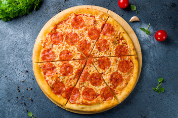 Pepperoni pizza on wooden board top view