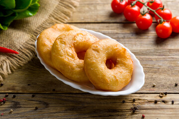 georgian donuts with cream on old wooden table