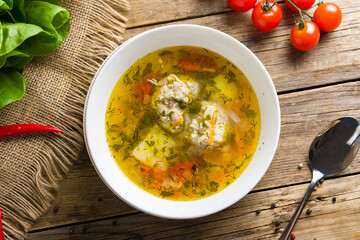 Chicken soup bouillon in a plate with meat balls