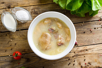 Khashlama with lamb on old wooden table, soup hash, khash