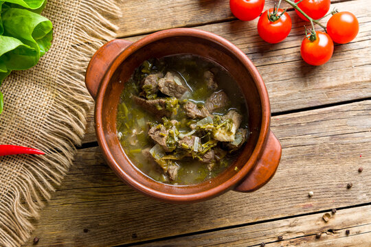 Chakapuli from lamb on wooden table top view