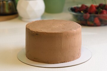 cake poured with chocolate on top with fruits and berries