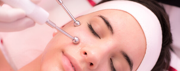Girl with facial mask lying in beauty health spa center	and receiving beauty skin care treatment
