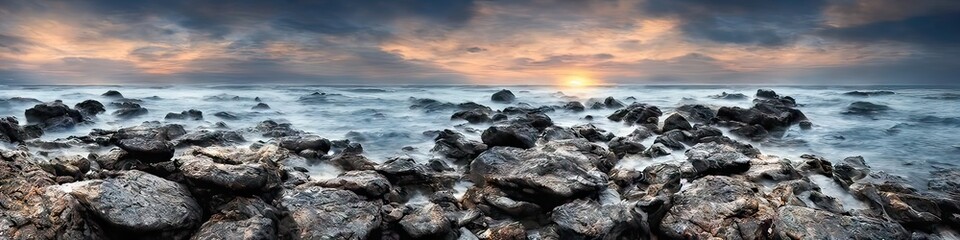 Rocky ocean shore featuring waves crashing against solid craggy stones breaching the ocean surface