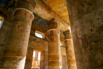 The Great Hypostyle Hall at the ancient Karnak Temple with giant painted sandstone columns in the form of papyrus stalks in Luxor, Egypt.