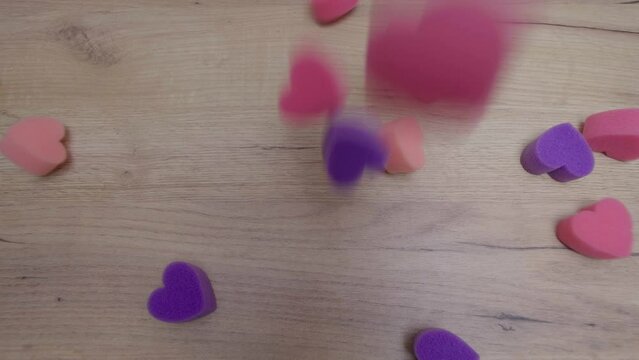 soft multi-colored hearts fall on the table