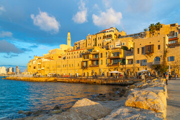 The old city of Jaffa, Israel, with medieval stone buildings along the Mediterranean Sea as the sun...