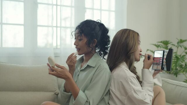 Beauty concept of 4k Resolution. Asian girls doing makeup together in the living room.