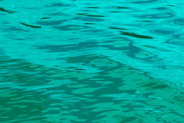 Fototapeta na wymiar Illustration of water ripple texture background. Wavy water surface during sunset, golden light reflecting in the water.