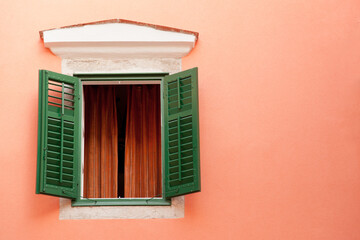 Traditional window with green shutters of the pink villa in the Rab  town, Kvarner region of Croatia