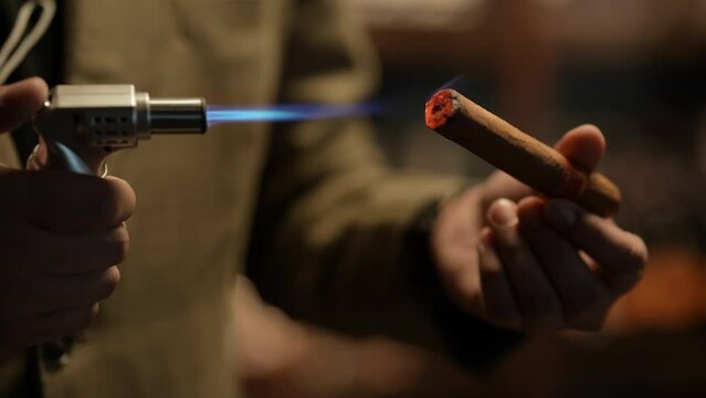 Night club concept of 4k Resolution. Businessman lighting a cigar in a nightclub.