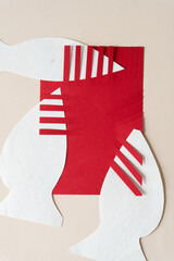 combined abstract white and red paper shapes - some with fringe edges - on blank paper