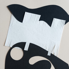 three combined abstract paper shapes - some with fringe edges and circle
