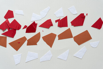 cut white, red, and brown paper pieces on blank paper