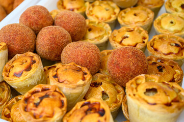 Traditional street food in UK, stuffed fried Scotch eggs with breadcrumbs and baked pie with pork meat