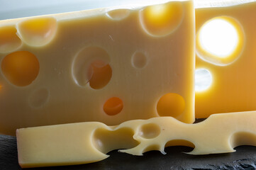 Swiss cheese collection, yellow emmentaler or emmental cheese with round holes