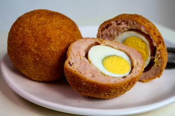 Traditional street food in UK, stuffed fried Scotch eggs with breadcrumbs