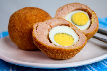Traditional street food in UK, stuffed fried Scotch eggs with breadcrumbs