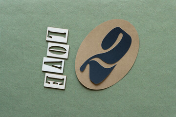 love and two on a paper oval on rough green paper