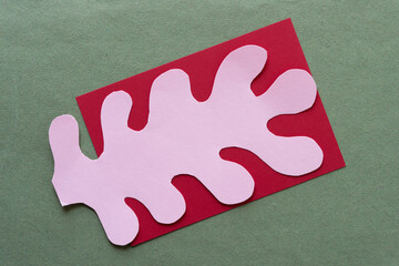 cut pink paper shape in the form of polyps, columnar, finger, fringe, or organics on red card and...