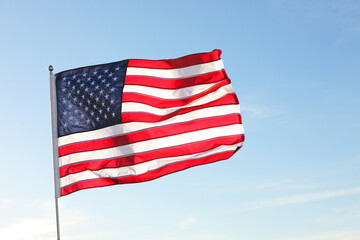 Obraz premium American flag fluttering outdoors on sunny day