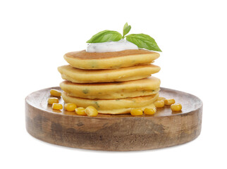 Stack of tasty corn pancakes with sweet kernels, sauce and basil isolated on white