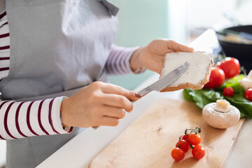 Unrecognizable woman making healthy dinner, preparing meal at home, cropped