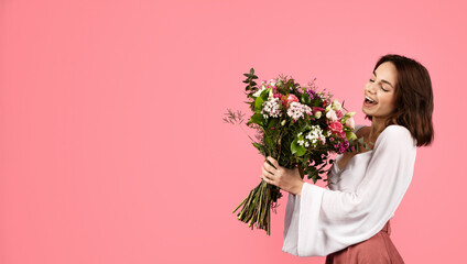 Happy inspired surprised young european woman enjoy bouquet of white tulips, rejoice spring holiday