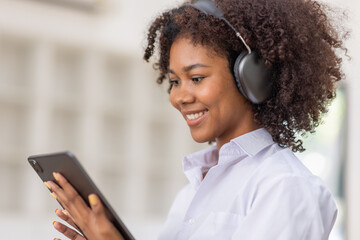 Black afro hair Young business woman wearing headphones in meeting room