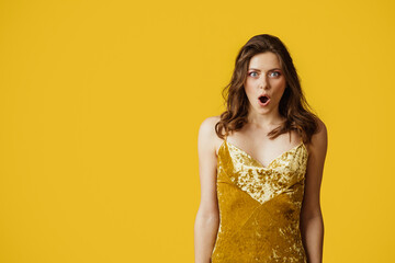 Omg. Portrait of shocked lady opening mouth in excitement, looking at camera with astonishment, yellow background