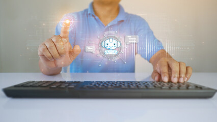 A young man sits in a office  with a HUD hologram in the foreground which is an AI Artificial Intelligence Robot Chat.Talk to Robot Chat to ask and answer questions in working job. ai concept