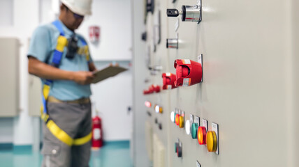 Engineers are performing daily electrical equipment and some parameter checks within the substation building to ensure they are in working order. Usable, industrial and technology work concept