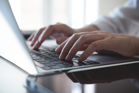 Close up, woman hands typing on laptop computer keyboard, surfing the internet on office table, online, working, business and technology, internet network communication concept