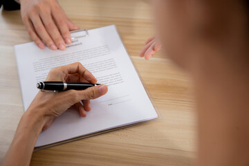 Hands of business woman signing and signature on contract about agreement with partner at office, document and deal with law while witness signing, recruitment and job interview, business concept.