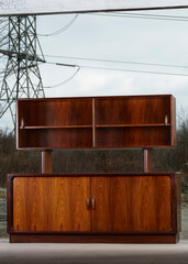 1960s wooden hutch cabinet. Mid-century modern rosewood credenza. Photographed outdoors. 