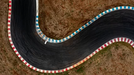 Fotobehang Aerial top view motorsport race asphalt track circuit motor racing track, Race track curve, Curving race track view from above, Aerial view car race asphalt track and curve. © Kalyakan