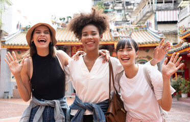 group of multi-ethnic female friends diversity enjoying the city tour. Young tourists having fun in...