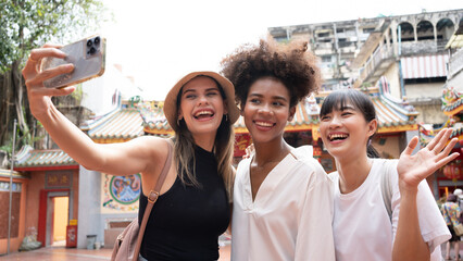 group of multi-ethnic female friends diversity enjoying the city tour. Young tourists having fun in...