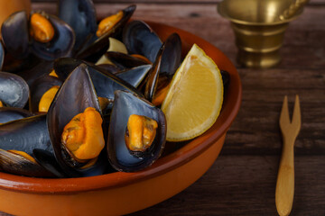 steamed mussels with lemon in an earthenware dish