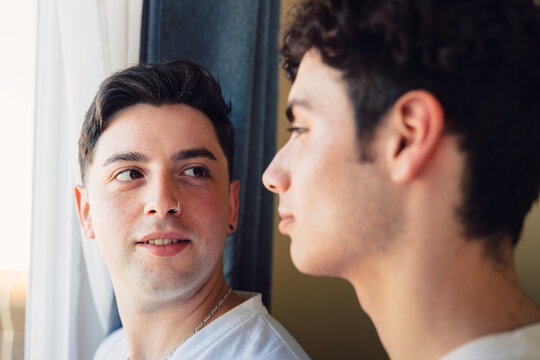 Gay Couple Sharing A Special Moment In The Morning By The Window. Homosexual Romantic Tenderness.