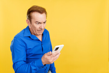 Mature man arguing during a video call with mobile