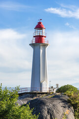 Fototapeta na wymiar Lighthouse on the rock in the ocean